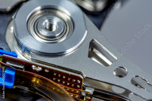 Disassembled hard drive from the computer, hdd with mirror effect. Opened hard drive from the computer hdd disk drive with mirror effects. Part of computer pc, laptop.