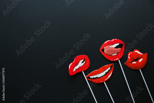 flatlay overhead top black paper photo booth props lip and mustache black background copy space.
