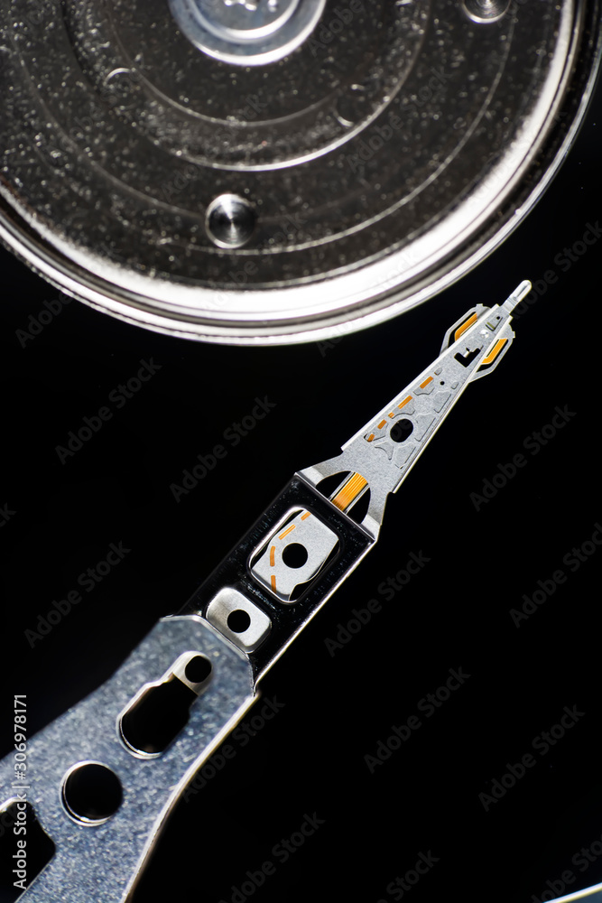 Disassembled hard drive from the computer, hdd with mirror effect. Opened hard drive from the computer hdd disk drive with mirror effects. Part of computer pc, laptop. Disassembled hard drive from the computer, hdd with mirror effect. Opened hard drive from the computer hdd disk drive with mirror effects. Part of computer pc, laptop.