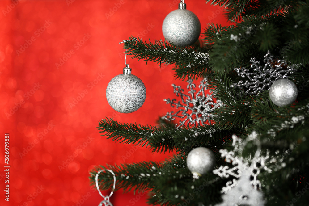 Fototapeta premium Christmas fir tree with ornaments on blurred lights background