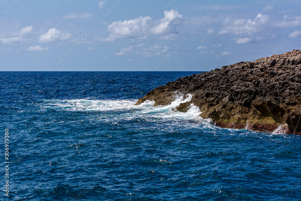 Waves beating against the rocks at the rugged coast in the South of Malta.