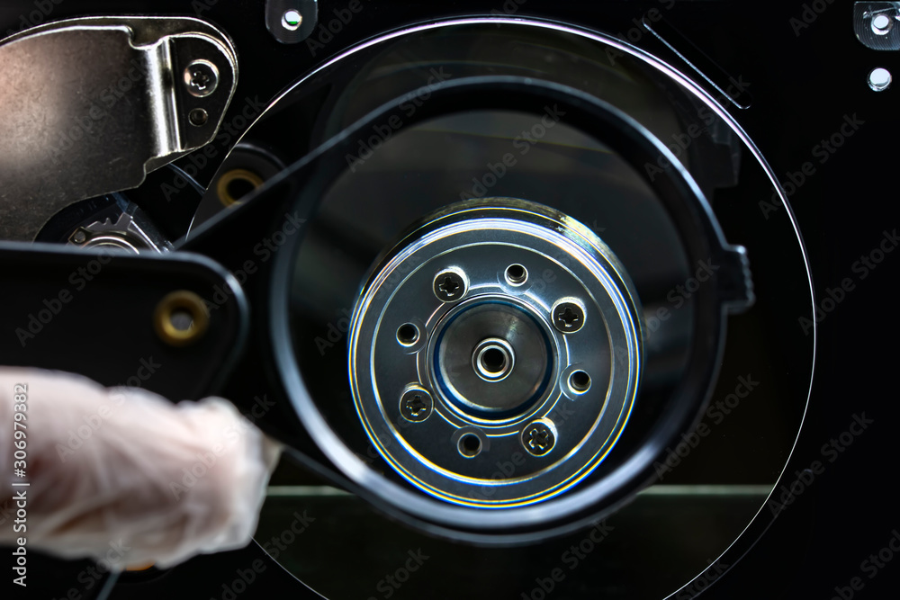 Fototapeta premium Disassembled hard drive from the computer, hdd with mirror effect. Opened hard drive from the computer hdd disk drive with mirror effects. Part of computer pc, laptop.
