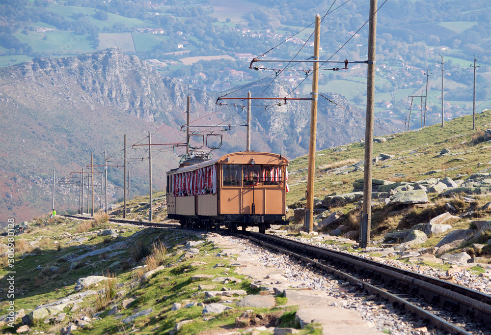 The train on the railway high in the mountains descends into the valley