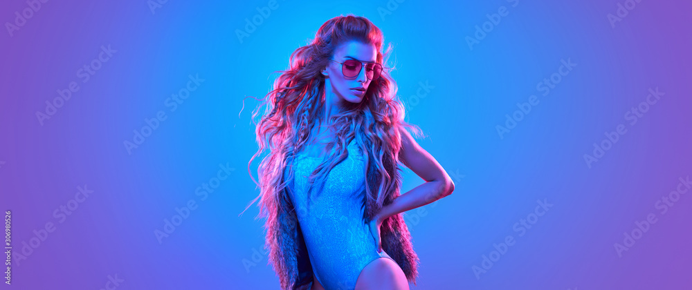 Fototapeta High Fashion. Party disco girl with pink neon hairstyle. Sensual beautiful woman in Colorful uv Light. Vibrant fashionable creative Style. Night Club music vibes. Gel filter light, art neon portrait