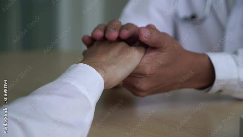 Hand of doctor reassuring patient Hand of doctor reassuring patient
