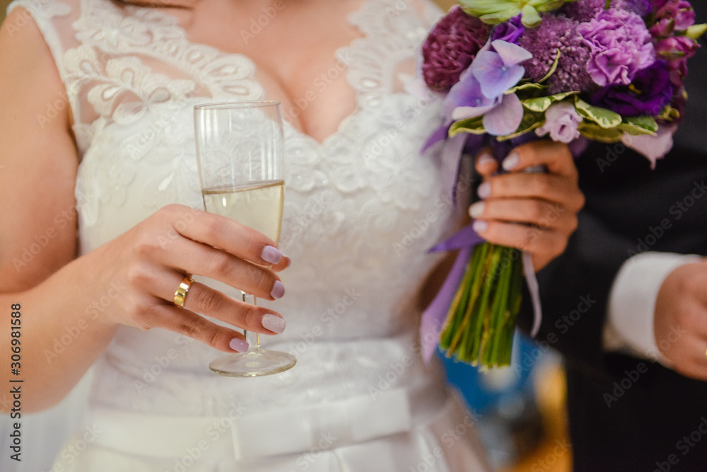 first toast of the bride and groom with a glass of champagne. first toast of the bride and groom with a glass of champagne.