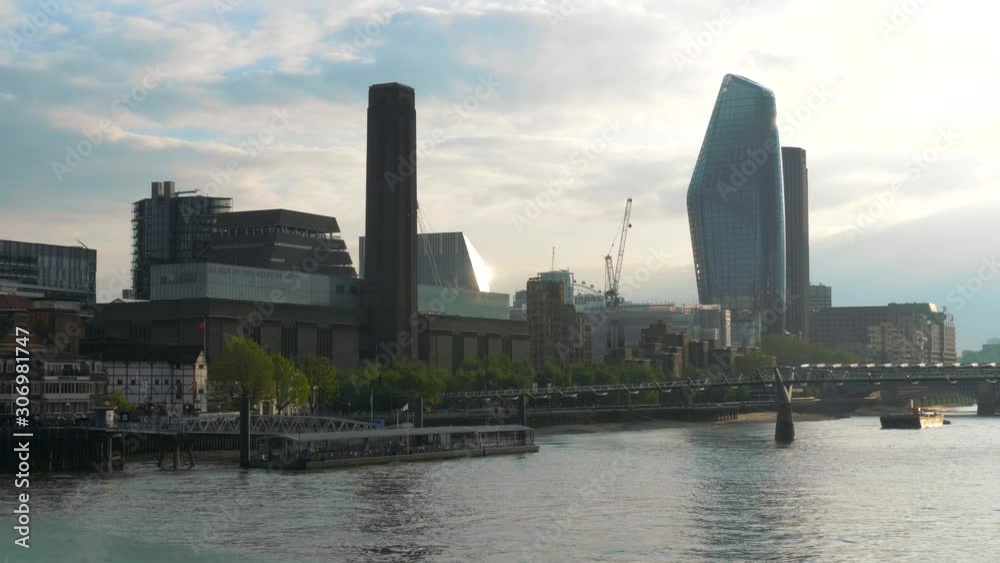 London Millennium Bridge at sunset time, next to the Globe Theater London. Cityscape of London overlooking the Millennium Bridge.