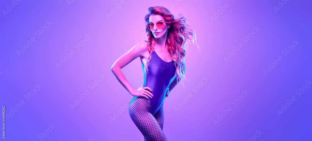 High Fashion. Party disco girl with pink neon hairstyle dance. Sensual beautiful woman in Colorful uv Light. Vibrant fashionable creative Style. Night Club music vibes, dancing, neon lighting color High Fashion. Party disco girl with pink neon hairstyle dance. Sensual beautiful woman in Colorful uv Light. Vibrant fashionable creative Style. Night Club music vibes, dancing, neon lighting color
