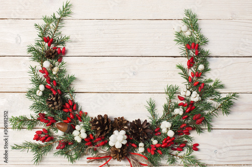 Christmas wreath on white wooden backdrop