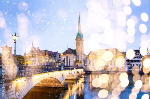 christmas lights and snow in  Zurich city center with famous Fraumunster and Grossmunster Churches and river Limmat at Lake Zurich, Canton of Zurich, Switzerland photo