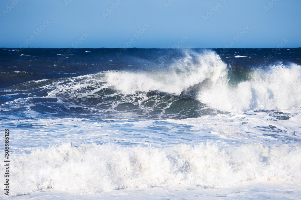 Big blue ocean wave crashing near the coast. Beautiful nature background