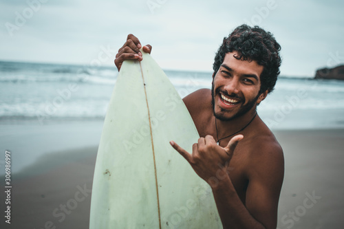  Black boy surfer on the beaches of Montañita, Ecuador photo