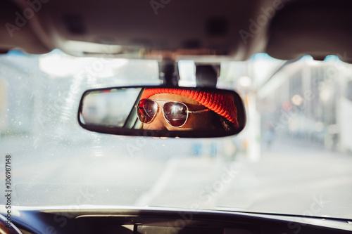 Driver looking through rear view mirror