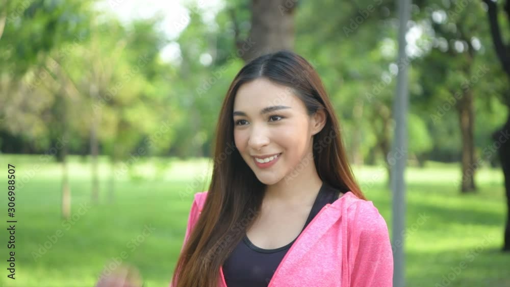 Holiday concept. Asian woman is smiling brightly in the garden. 4k Resolution. Holiday concept. Asian woman is smiling brightly in the garden. 4k Resolution.