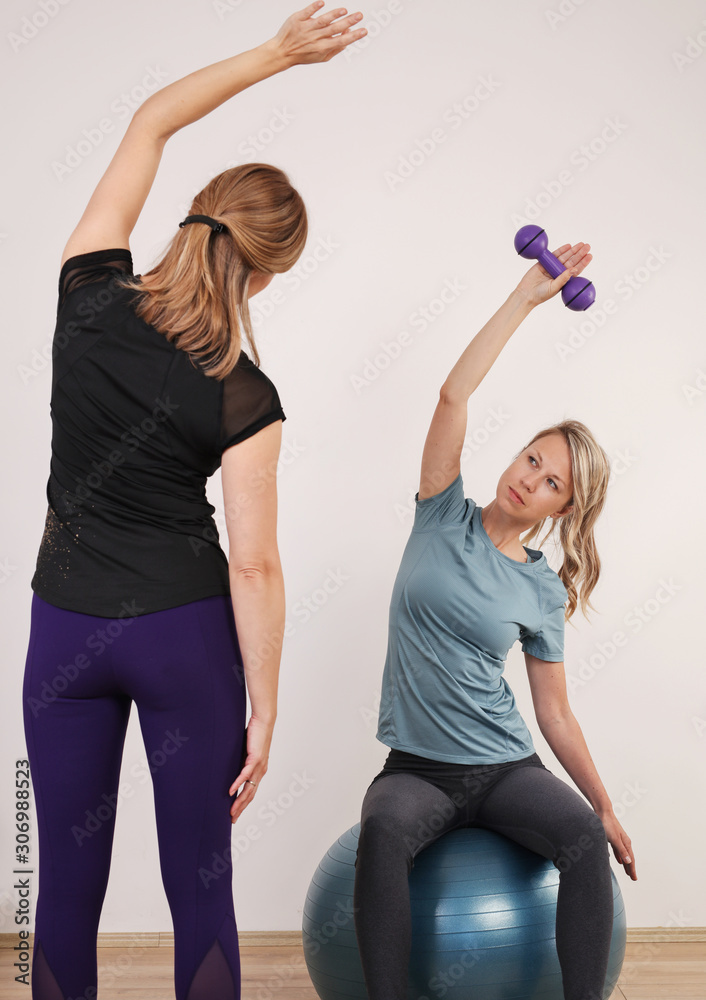 Female Personal Trainer, Pilates class. Corrective gymnastics