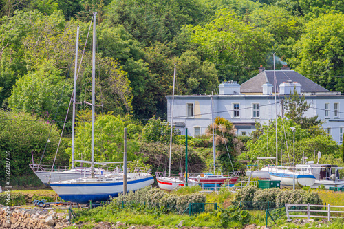 Boats out of the water in the port of Clifden next to the pier, sunny spring day in the province of Connacht, Ireland photo