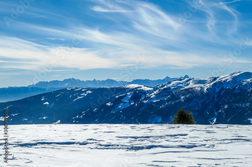 Sunny winter day in the austrian alps in the ski resort of  Bad Kleinkirchheim, Austria. The snow shows a nice reflection. Winter sports in Alpine winter wonderland photo