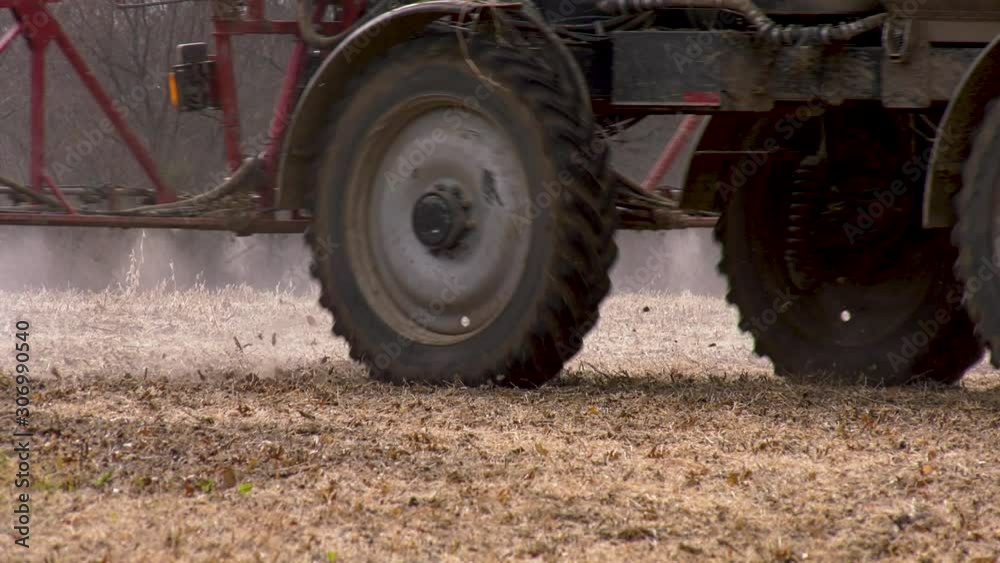 Close up on sprayer arms of an agriculture tractor in a field Close up on sprayer arms of an agriculture tractor in a field
