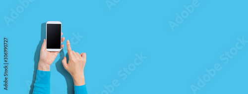 Person using a white smartphone - overhead view