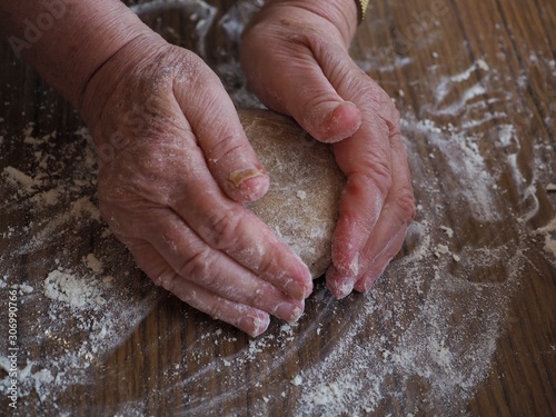 Senior womans hands kneading gingerbread dough 