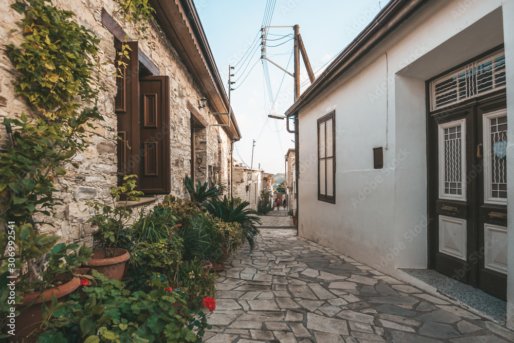 Beautiful narrow street of Lefkara village, Cyprus with flower pots and masonry.