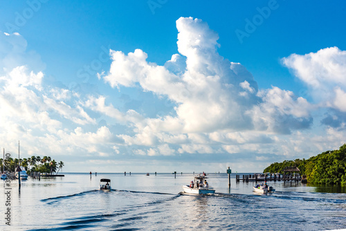 Boats heading out into Biscayne Bay, Florida from Matheson Hammock Park Marina on a beautiful bright Summer Day