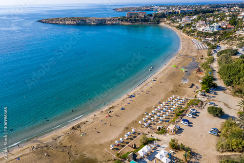 Aerial top view of famous Coral Bay Beach near paphos, Cyprus. Idyllic tropical landscape for rest with sandy beach and clear azure water. © DedMityay