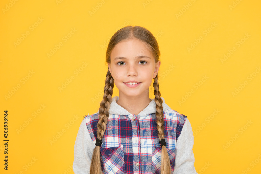 Cute braided girl. Kid long hair. Small girl checkered shirt. Happy international childrens day. Little girl yellow background. Good mood concept. Positive vibes. Sincere emotions. Having fun Cute braided girl. Kid long hair. Small girl checkered shirt. Happy international childrens day. Little girl yellow background. Good mood concept. Positive vibes. Sincere emotions. Having fun