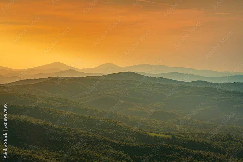 Beautiful sunset over the hills near Montalcino. Travel destination Tuscany, Val d'Orcia, Italy