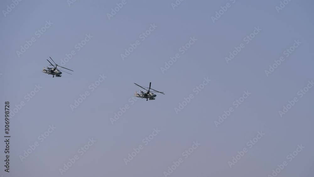 Flying a couple of helicopters over the mountains. Aerobatics. Helicopter flight in the sky. Kamov helicopters with two rotors. Helicopters with coaxial propellers. Flying a couple of helicopters over the mountains. Aerobatics. Helicopter flight in the sky. Kamov helicopters with two rotors. Helicopters with coaxial propellers.