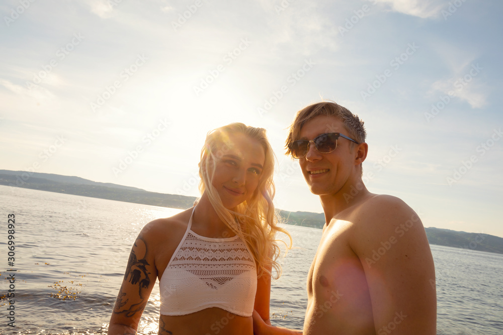 Fototapeta premium Portrait Of Beautiful Smiling Young Man And Woman At Beach