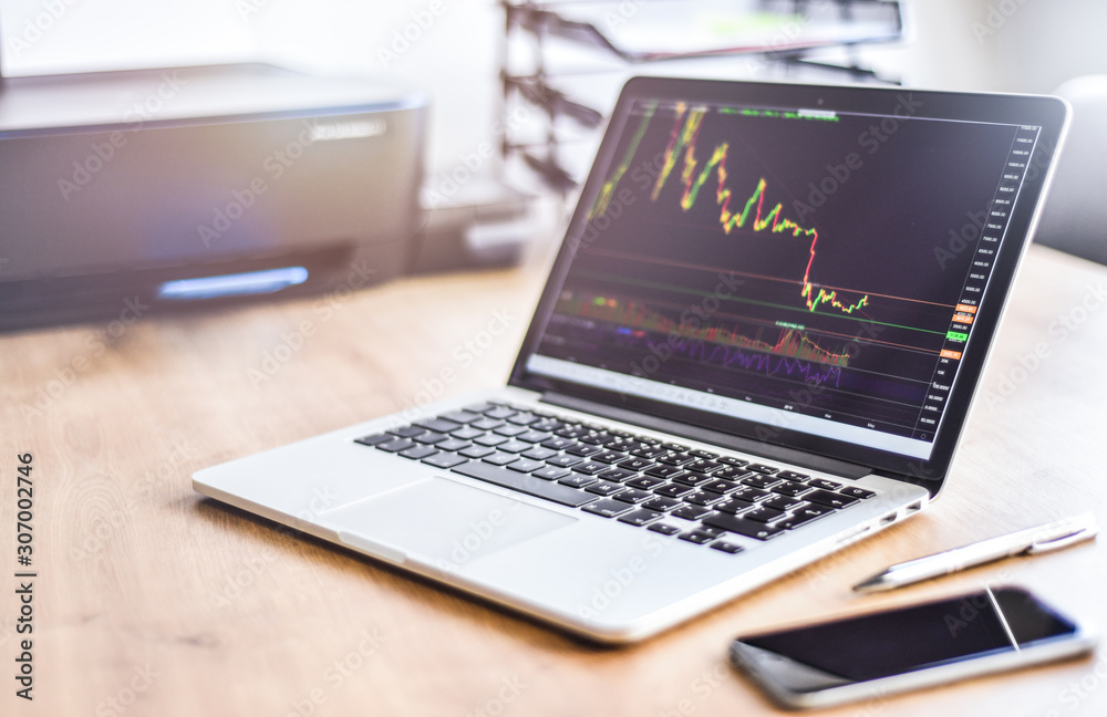 Modern laptop with financial bitcoin cryptocurrency crypto graph data trade. Computer notebook workplace detail. Modern laptop with financial bitcoin cryptocurrency crypto graph data trade. Computer notebook workplace detail.