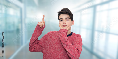 portrait of young or thoughtful student raising hand