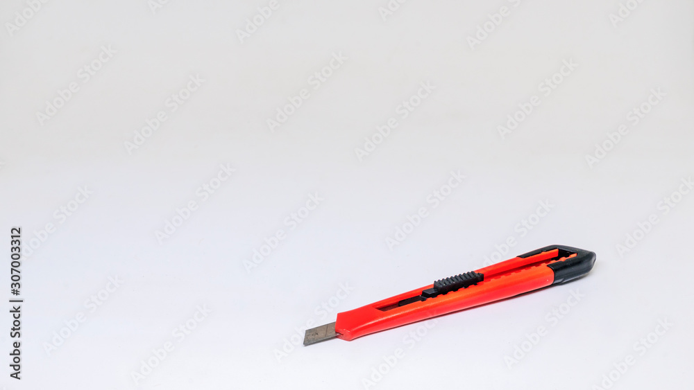 Red paper knife isolated on white background. Isolated view. Red paper knife isolated on white background. Isolated view.