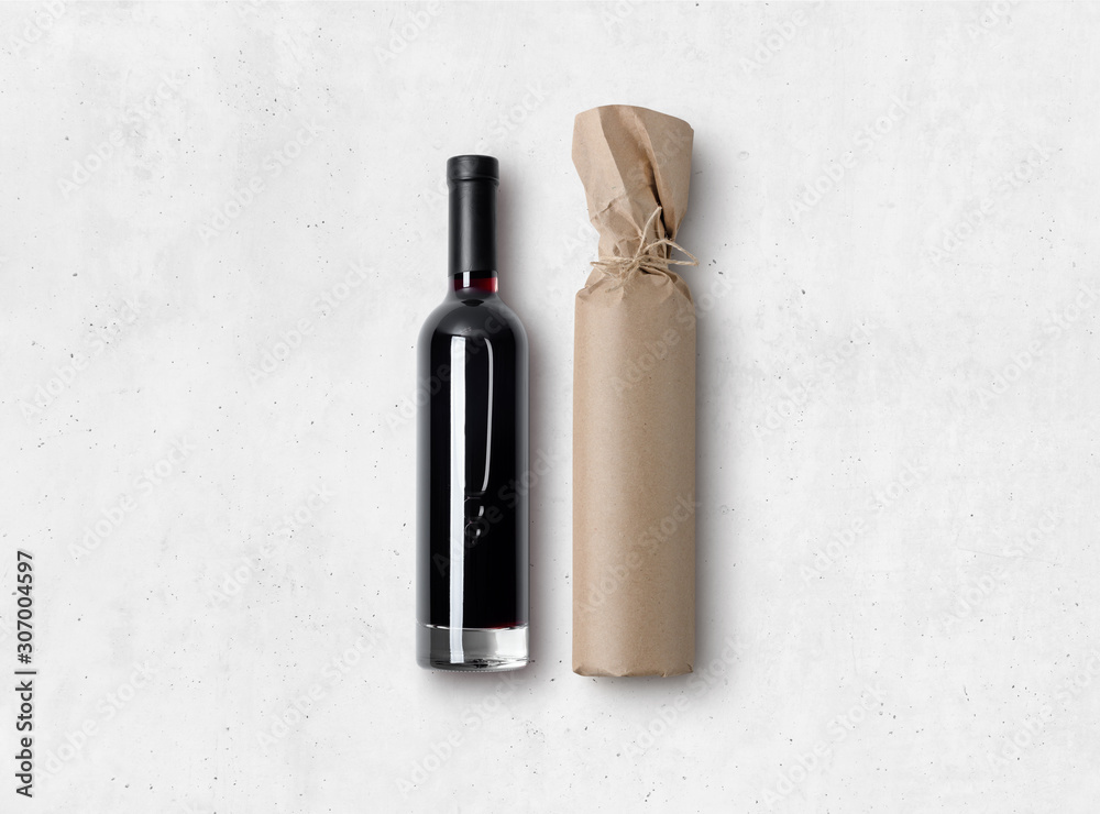 Mock-up of a bottle of red wine and bottle wrapped in craft paper on concrete background. Blank objects for placing your design. 3d illustration. Mock-up of a bottle of red wine and bottle wrapped in craft paper on concrete background. Blank objects for placing your design. 3d illustration.