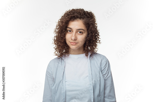 Portrait of a pretty hispanic young woman on a white background.