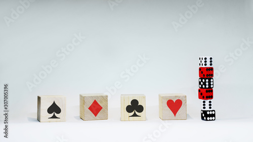 Card suits with wooden symbol with six dices on white background. photo