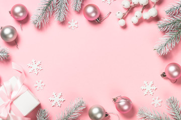 Christmas present box and decorations on pink background.