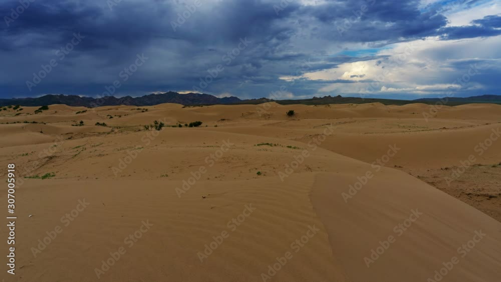 Sand dunes with storm clouds at sunset in Gobi Desert, Mongolia, timelapse 4k Sand dunes with storm clouds at sunset in Gobi Desert, Mongolia, timelapse 4k