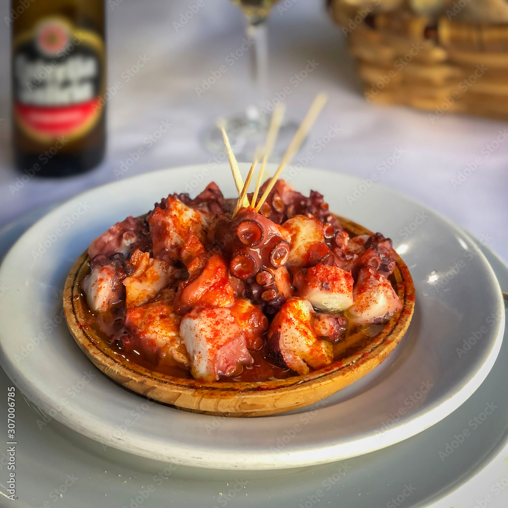 Octopus in spicy sauce in plate, spanish style closeup. Octopus in spicy sauce in plate, spanish style closeup.