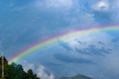 rainbow against the blue stormy sky