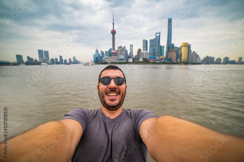 Photography Happy tourist man take selfie with Shanghai skyline, handsome similing man trave