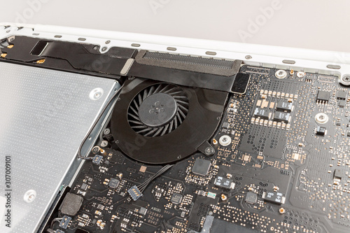 laptop cooling system close-up with rotating fan, CPU cooling and overheating, trottling photo