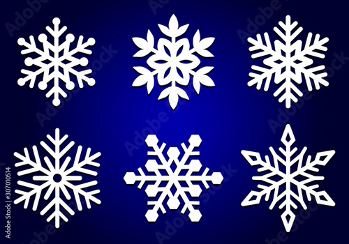 Set of laser cutting openwork snowflakes. Vector silhouette of christmas decoration. Template for paper isolated on blue background. Stencil for scrapbooking, carved wood.