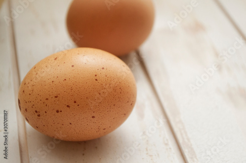 Eggs on weathered wooden table in shebby style, close up photo