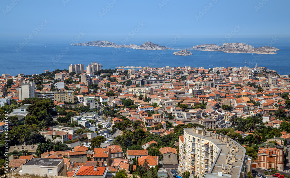 Fototapeta premium Marseille, France. Aerial panoramic view of the city, the bay and islands from the top of the hill in a summer sunny day. Holidays in France.