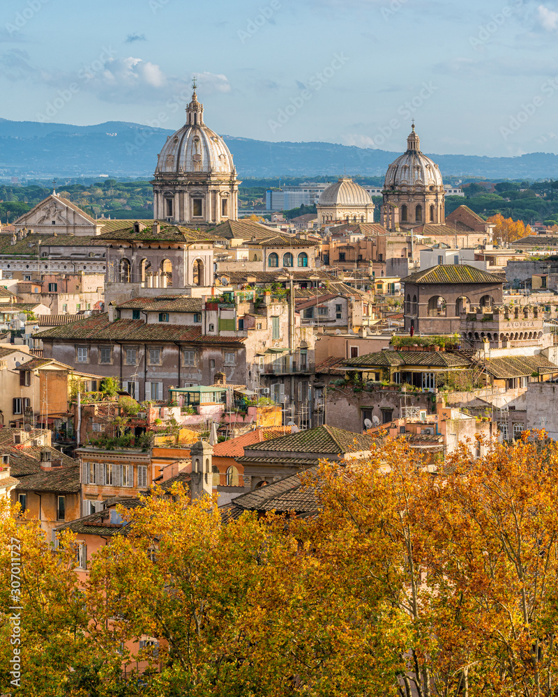 Rome skyline during autumn season, as seen from Castel Sant'Angelo, with the domes of the churches of Sant'Andrea della Valle and San Carlo ai Catinari.