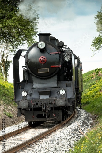 A steam passenger train arrives