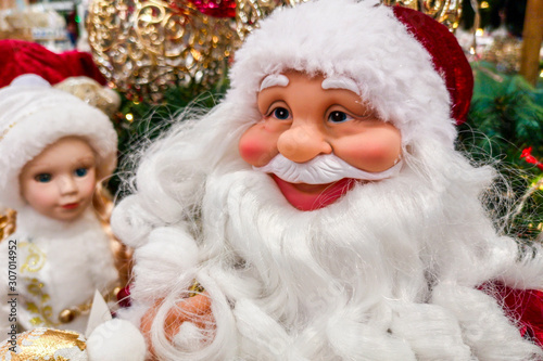 Toy Santa Claus closeup. Traditional christmas toy fair. Preparation for holidays, sale in a toy store. Christmas toy