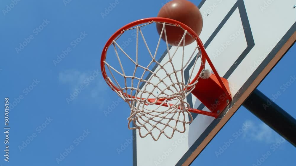 Close view of a basketball hoop, player scores, 4k slow motion Close view of a basketball hoop, player scores, 4k slow motion